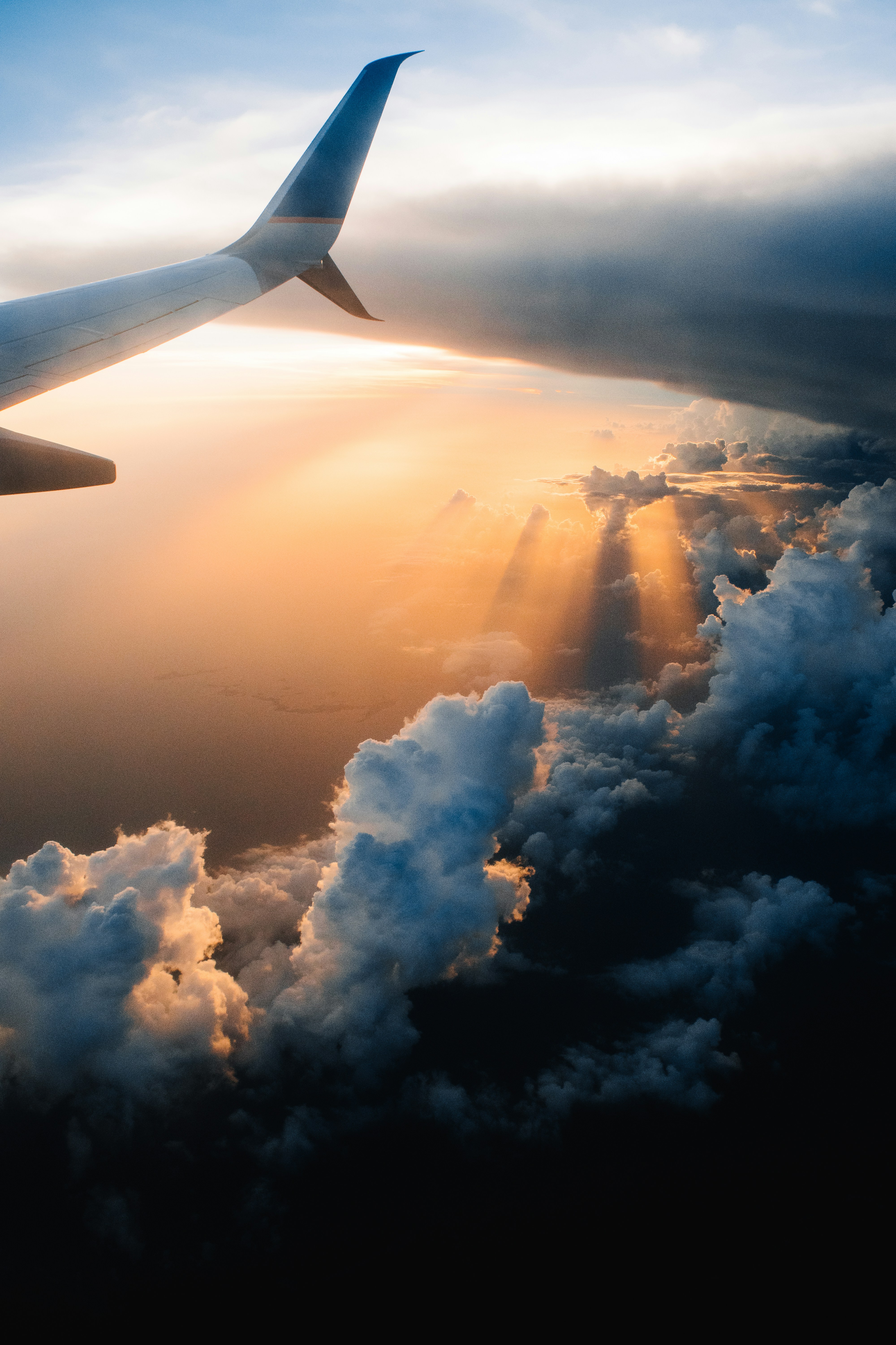 This is taken after passing through a severe storm in a plane. This being one of my first flights, I felt lucky to make it out safely and even luckier to capture such a beautiful sunset.